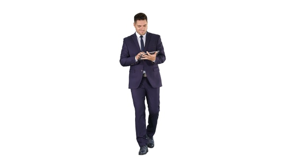 Man in suit walking and using digital tablet on white background