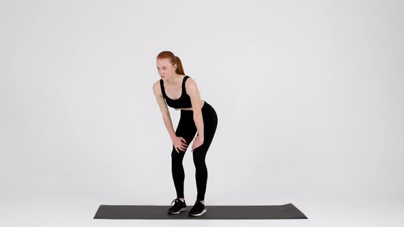 Athletic Young Woman Doing Stomach Vacuum Exercise While Training In Studio