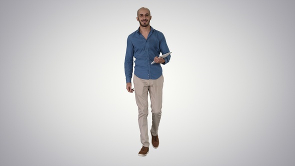 Arab presenter walking with digital tablet swiping pages