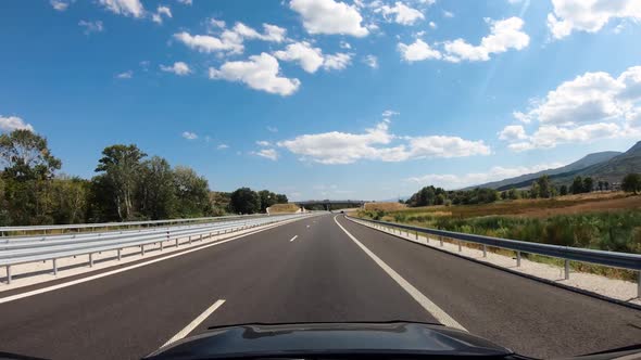 Summer Road Trip on Europe Firstperson View of a Moving Car on a Highway Ride Near Bridges and Road