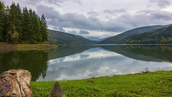 Clouds With Reflections in a Mountain Forest Lake