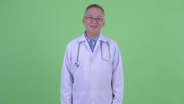 Happy Mature Japanese Man Doctor Smiling