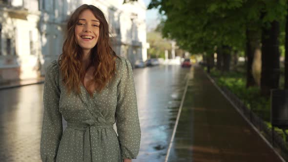 Portrait of Caucasian Gorgeous Woman 20s Wearing Stylish Summer Dress Laughing While Walking Through