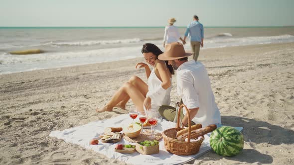 Beautiful Stylish Young Family Couple Happy Husband and Wife Sit on Cozy Picnic Blanket