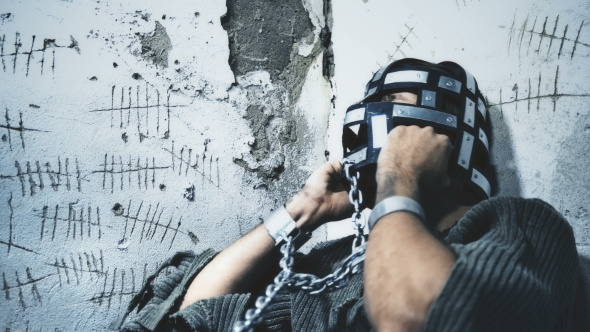 Prisoner in Chains Eats Food Brought