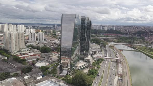 Mirrored two Building and Clouds with Cars and River Drone 4k