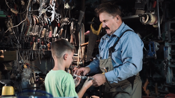 Grandpa Carpenter with His Grandson in the Workshop