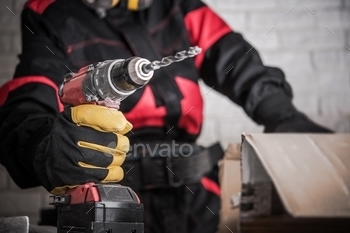 rker with Powerful Cordless Drill Driver in Hand. Drilling Makes Easy Concept.