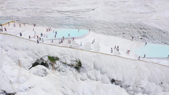 Panoramic Fly Over Pamukkale Mountain with Tourists Walking Near Travertines