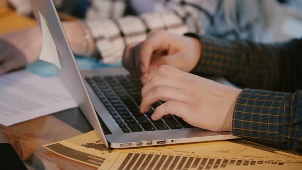 Close-up Shot of Male Code Developer Hands Typing, Working Behind Office Table with Laptop at Modern