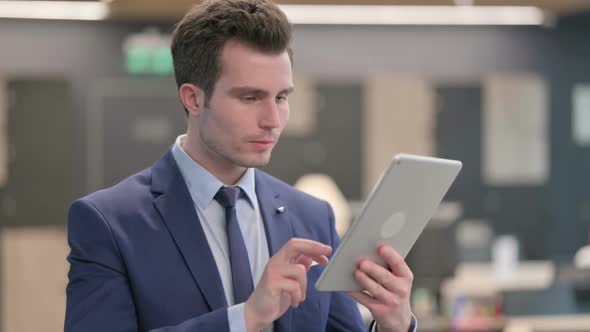 Portrait of Businessman Having Loss on Tablet in Office