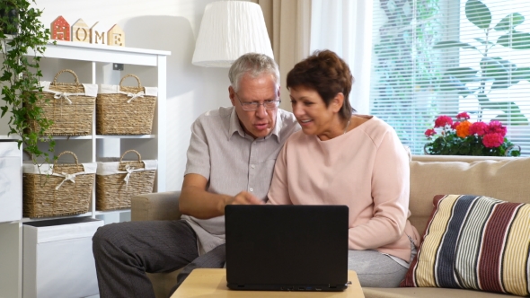 An Elderly Couple Communicates with Laptop Video Call