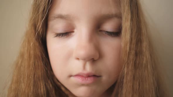 Close Up Female Face of Desperate Child Looking Down Indoor