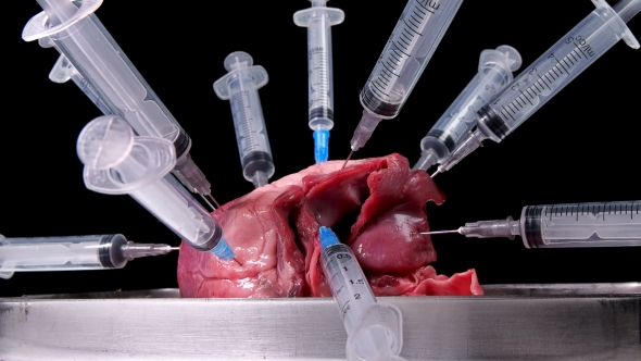 Heart Pricked with Syringe on Black Background