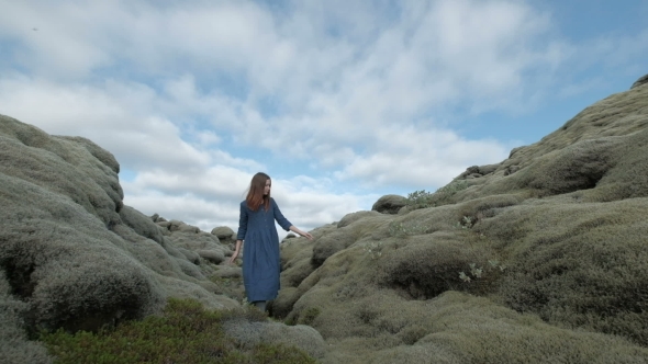 Young Summer Beauty. Red Haired Girl in Blue Dress on Green Mossy Icelandic Landscape
