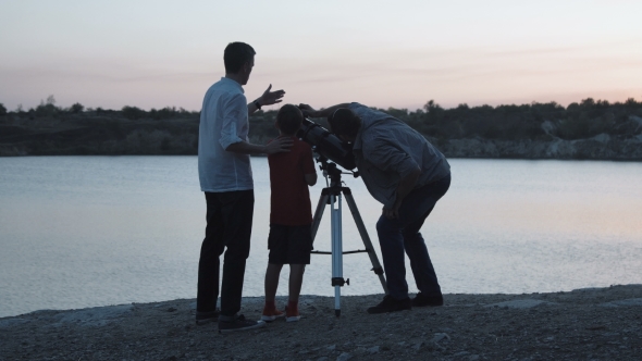 People Exploring Stars on Shore of Lake alt