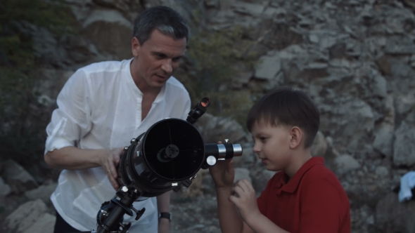 Man with Boy Using Telescope