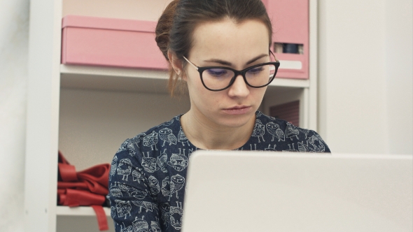 Portrait of Casual Female Designer Working on Laptop at Workplace