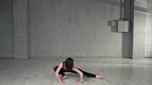 Young Female Dancer Stretching in Studio