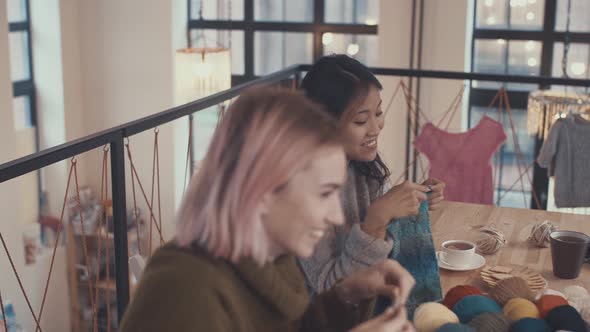 Smiling girls in a knitting studio