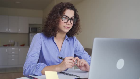 Concentrated Latin Young Woman Freelancer Working Online on Computer Laptop