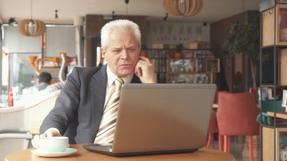 Senior Businessman Looking at the Laptop Screen