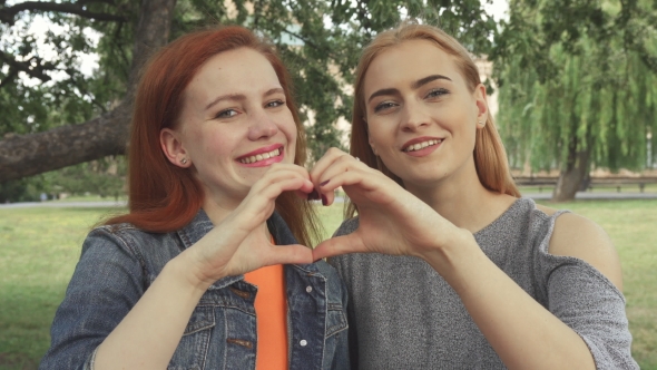 Two Girls Posing for a Camera