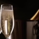 Champagne. Two Flutes with Bottle of Champagne in an Ice Bucket at Background. - VideoHive Item for Sale