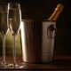 Champagne. Two Flutes with Bottle of Champagne in an Ice Bucket at Background. - VideoHive Item for Sale