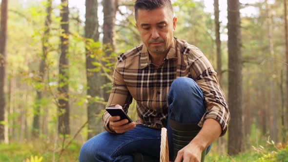 Man Using Smartphone To Identify Mushroom