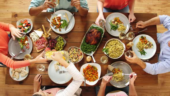 Group of People Eating at Table with Food