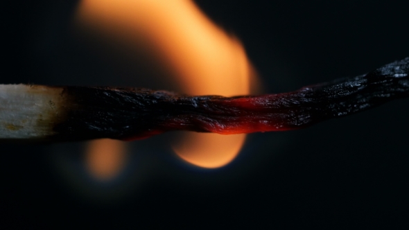 Burning Match On Black Background