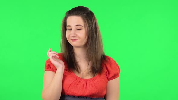 Portrait of Cute Girl Coquettishly Smiling, Waving Hand and Showing Gesture Come Here. Green Screen