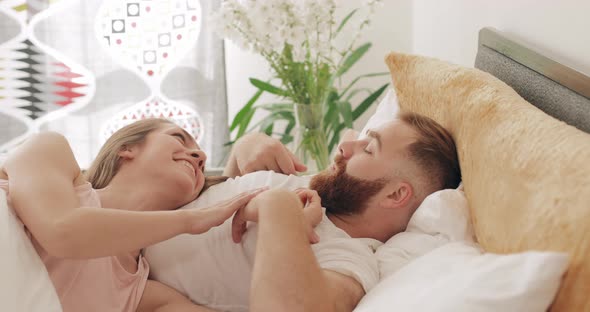 Good Looking Man and Woman Communicating and Smiling While Lying on Bed, Loving Young Couple Talking