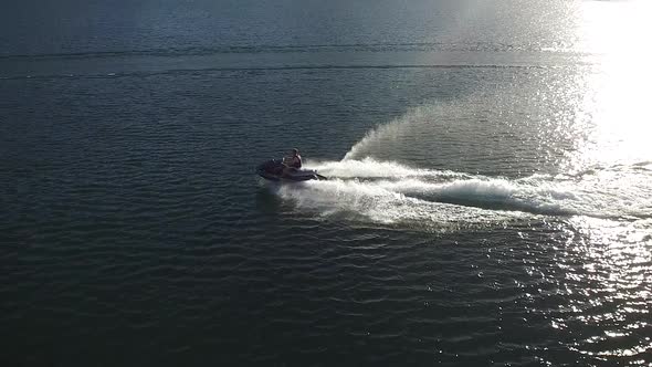 A nice summer day out on the lake enjoying some watersports with boats and personal watercraft.