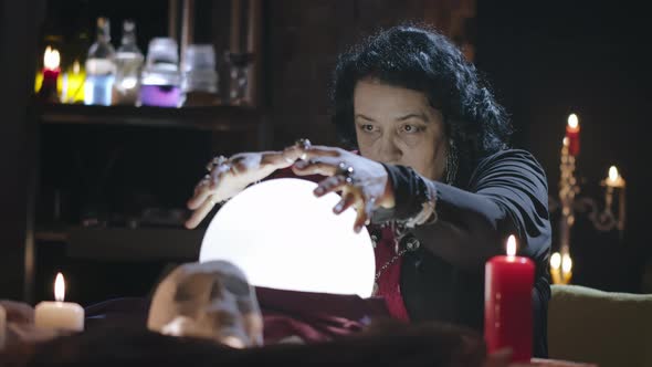 Mature Female Sorcerer Working with Crystal Ball