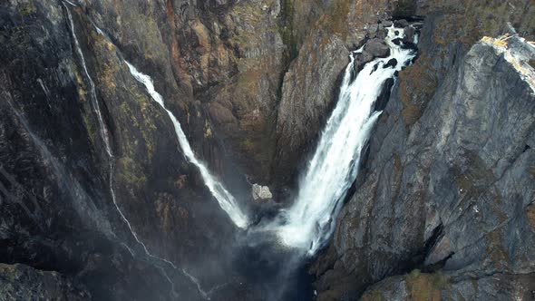 Aerial Overhead View Of Cascading Voringsfossen Waterfall In Norway. Pedestal Rising, Tilt Down