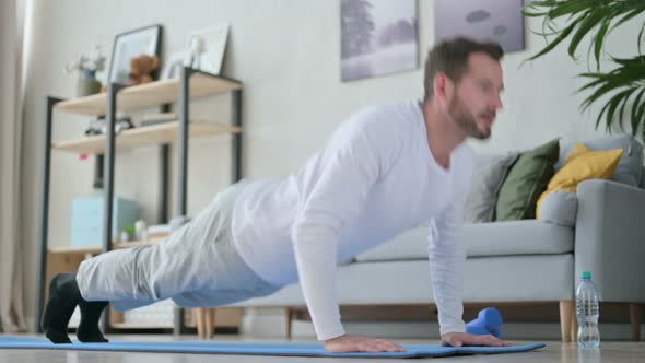 Man Doing Pushups on Yoga Mat at Home