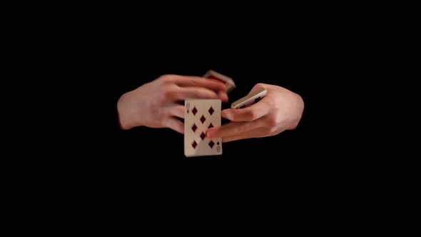 Playing Cards Trick Making By Magician Known As Kardistri on Black Background