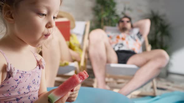 Video of girl eating a watermelon during vacation at home. Shot with RED helium camera in 8K.