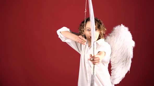 Woman As Cupid Angel Aiming with Wings, Bow and Arrow. Valentine's Day. Valentine Female.