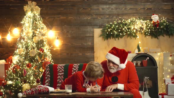 Grandfather and Grandson Prepare Christmas or New Year at Xmas Tree, Happy Child Write Wish Letter