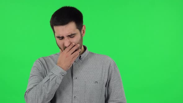 Portrait of Brunette Guy Is Clapping His Hands Indifferent. Green Screen