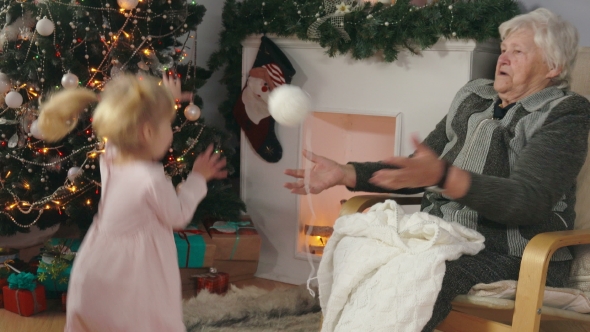 Grandmother Plays a Ball with Her Granddaughter