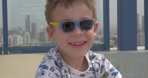 Portrait of happy kid in funny sunglasses