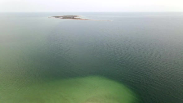 Small Uninhabited Sand Island in Ocean Reef,  Drone High Ungraded Video