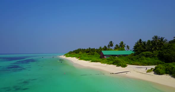 Natural flying clean view of a paradise sunny white sand beach and turquoise sea background in vibra