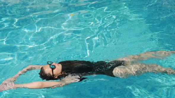 Girl in a Black Bathing Suit and Sunglasses