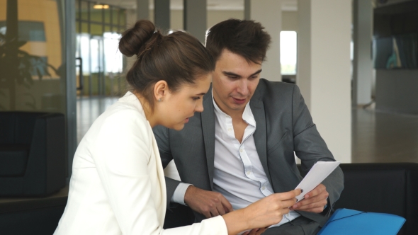 Young Businesswoman Talking with a Colleague About the Business Plan