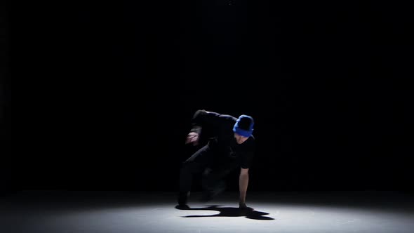 Dancer Man in Hat Starts Dancing Breakdance on Black